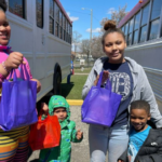 Four children hold up their Easter Bags