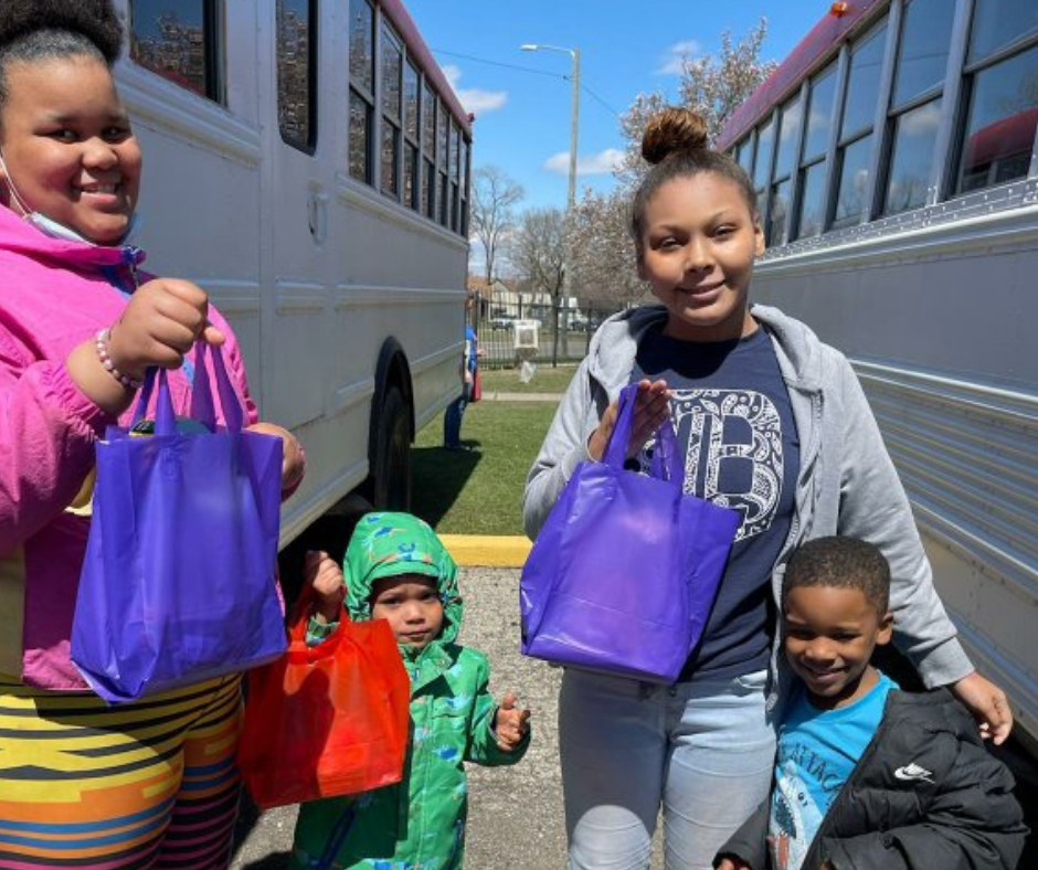 Four children hold up their Easter Bags