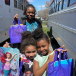 Children hold up their Easter Bags